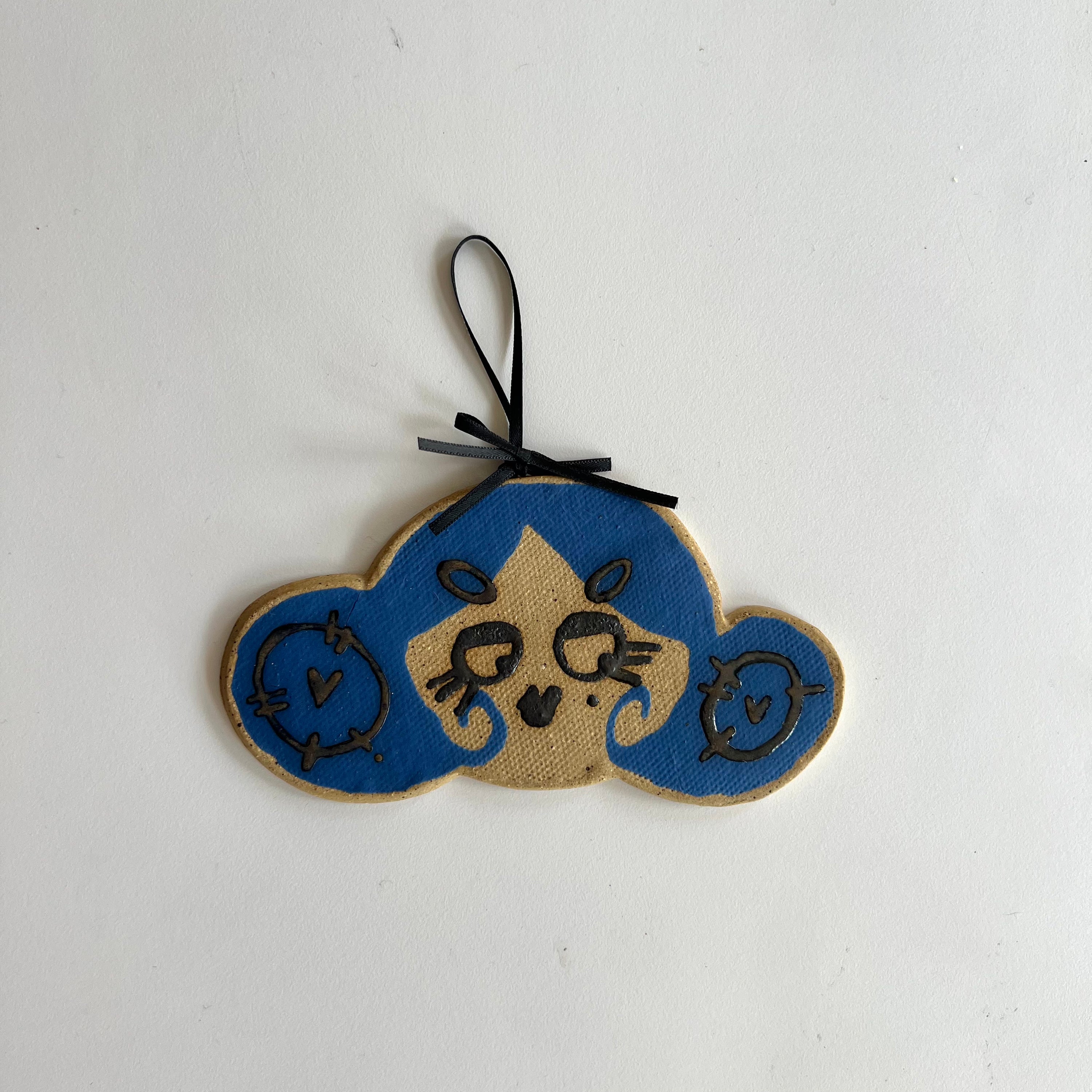 true blue moonie ceramic wall hanging
