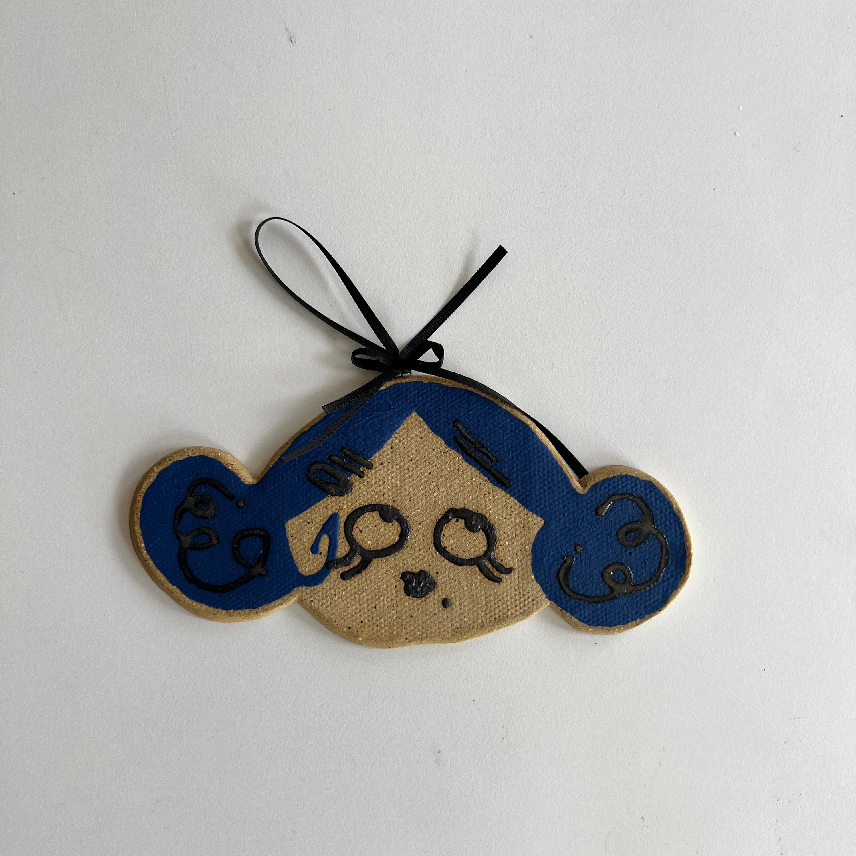 dark blue moonie ceramic wall hanging