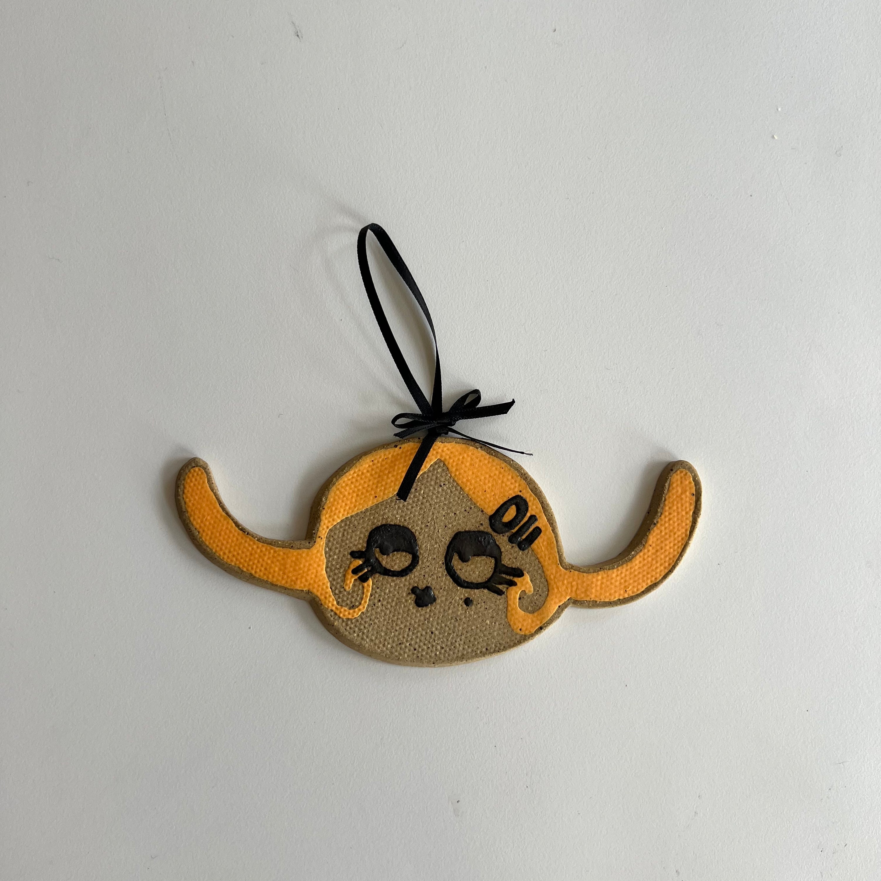 orange pigtails ceramic wall hanging