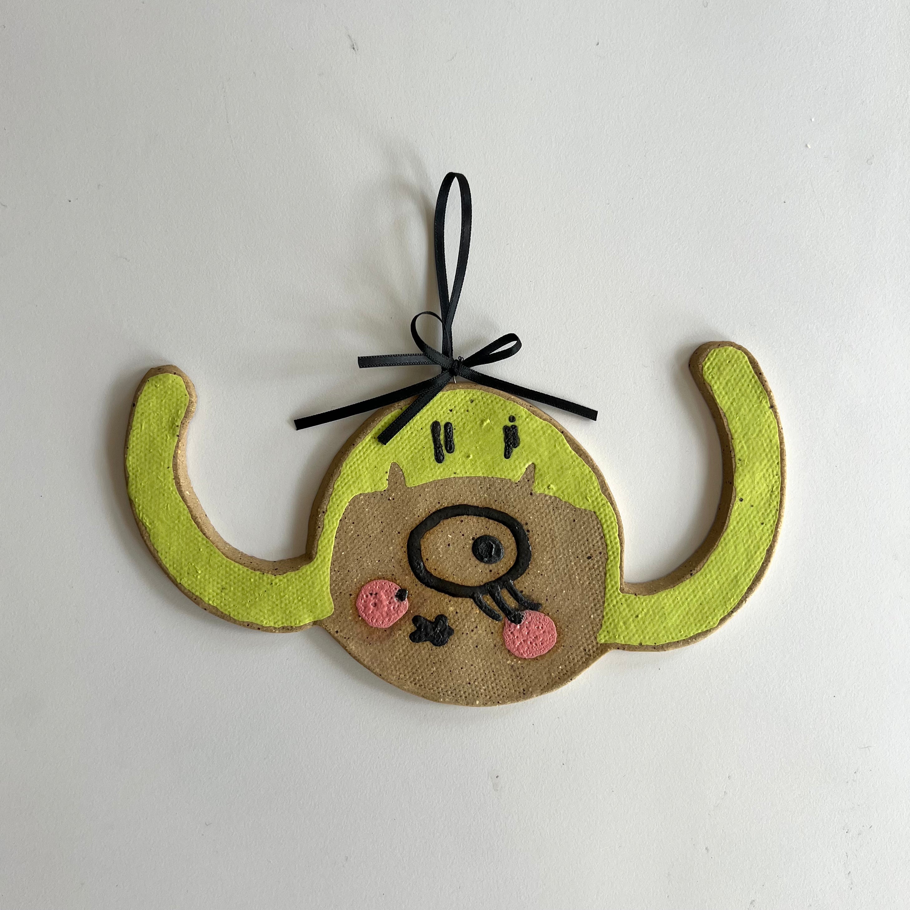 cyclops pigtails ceramic wall hanging